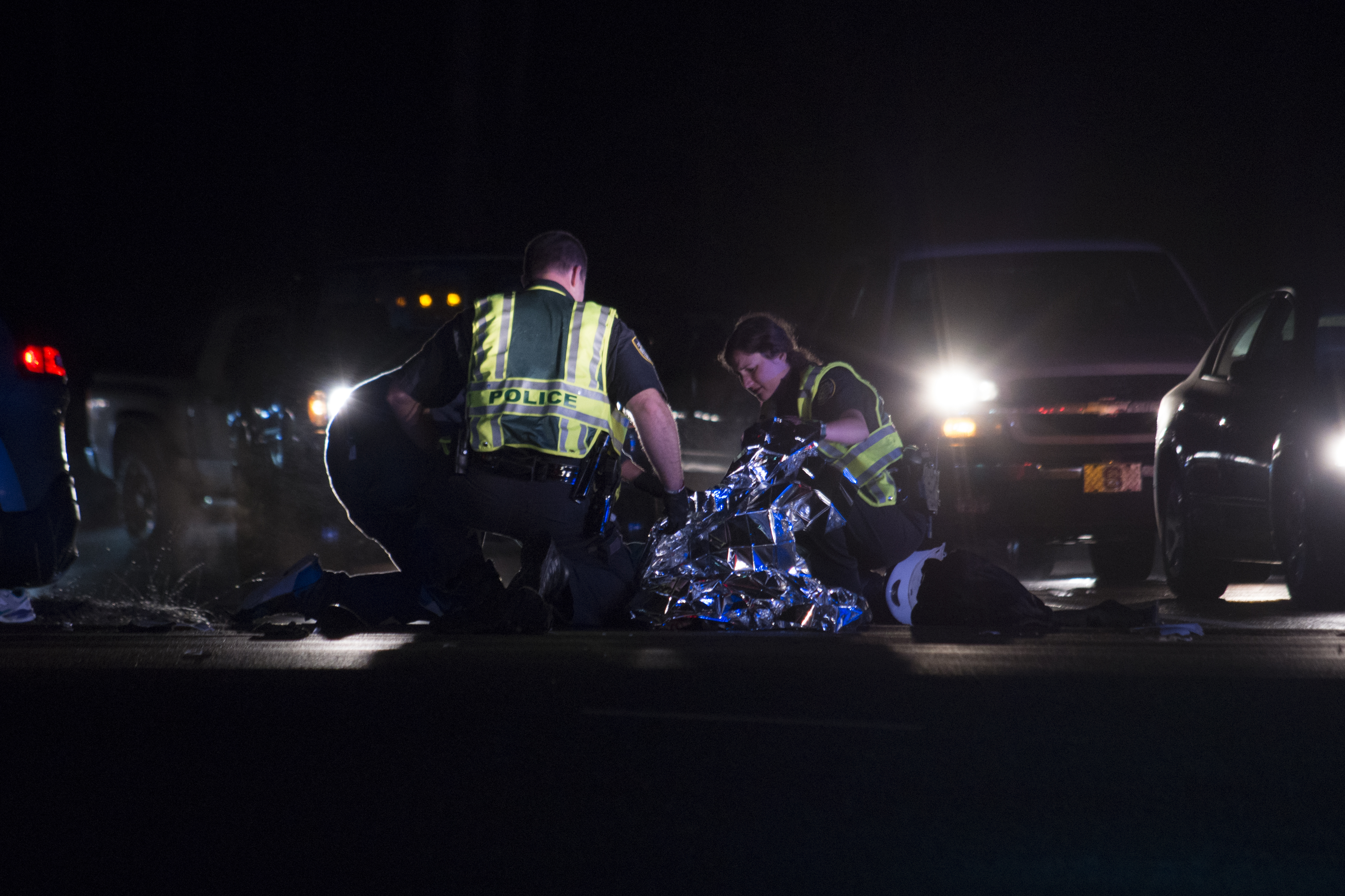 Police Place Blanket Over Injured Motorist